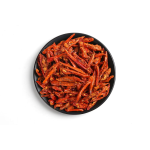 Crispy chili pepper snack with sesame in a black bowl