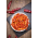 Crispy chili pepper snack with sesame in a white bowl on slate