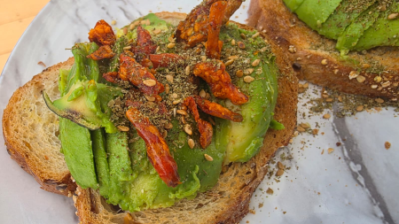 Avocado toast topped with crispy chili pepper pieces, serving suggestion