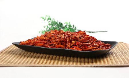 Crispy chili pepper snack served on a black rectangular plate